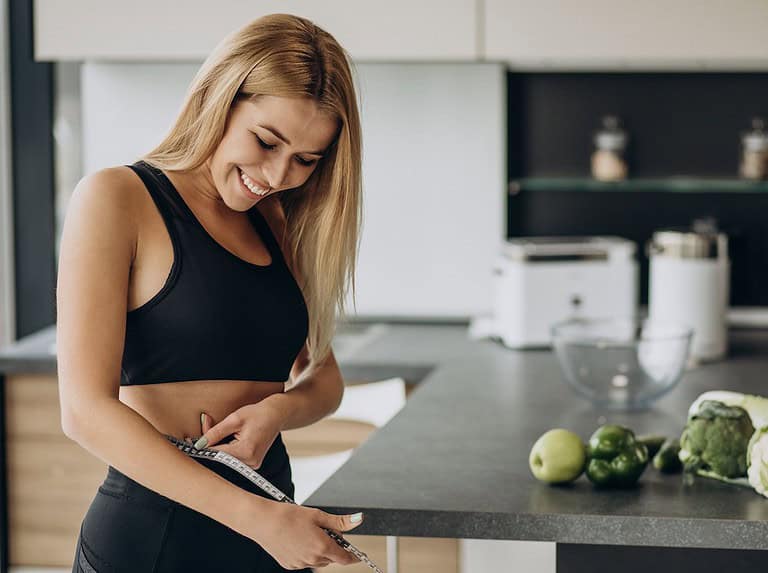 Woman measuring her waist (attribution senivpetro)