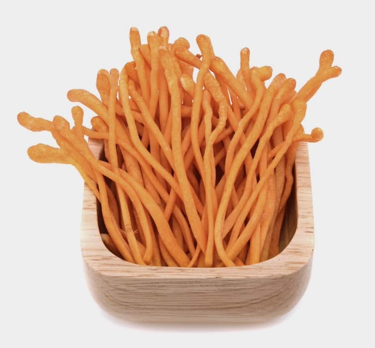 Cordyceps militaris mushrooms on a wooden bowl